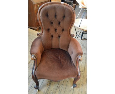 A Victorian brown upholstered button backed armchair