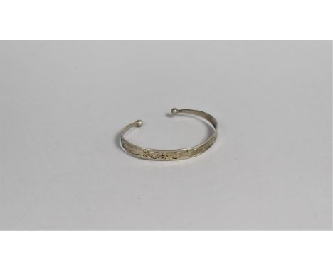 A White Metal Bangle with Engraved Decoration 