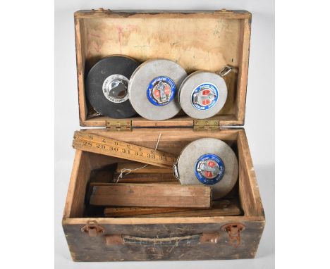 A Vintage Wooden Tool Box Containing Folding Rulers and Metal Tape Measures 