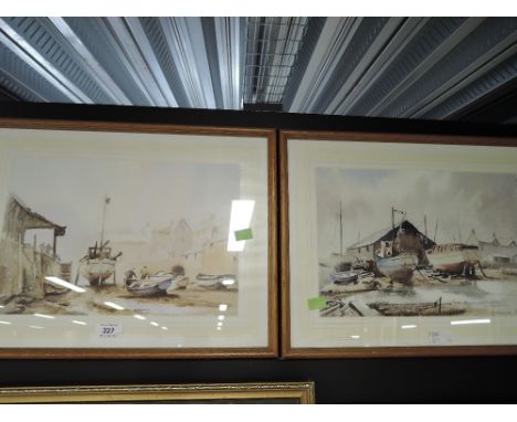 A pair of vintage prints depicting boats on shore
