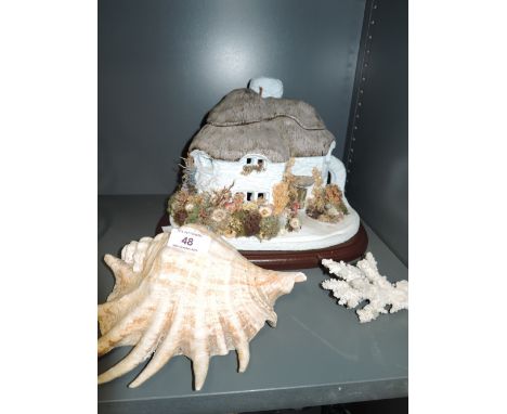 A vintage lamp base modelled as a thatched house