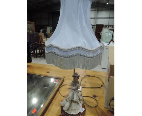 A modern table lamp having figural base
