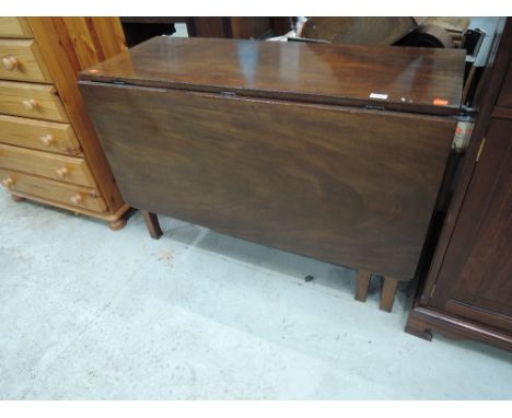 An early 19th century mahogany dining table having rectangular drop leaf on square gate legs