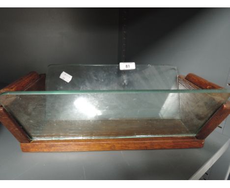 A vintage oak and glass book trough