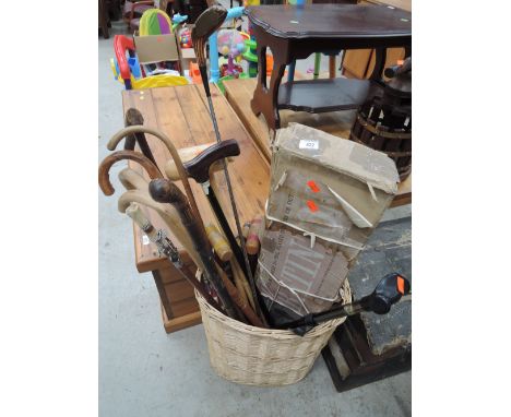 A wicker basket of stick, clubs etc inc. croquet set 