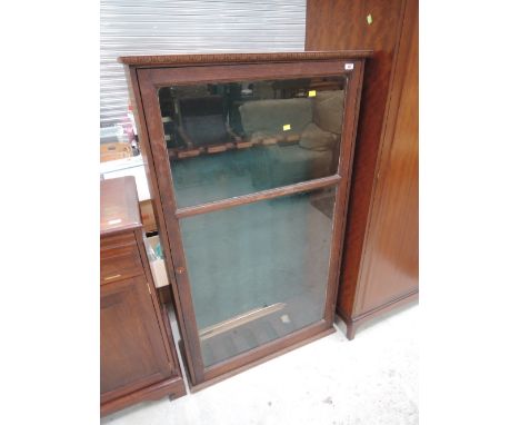 An early 20th Century oak glass fronted gun cabinet