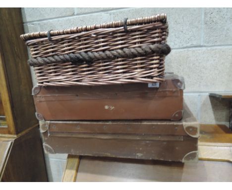 Two vintage suitcases and a wicker hamper