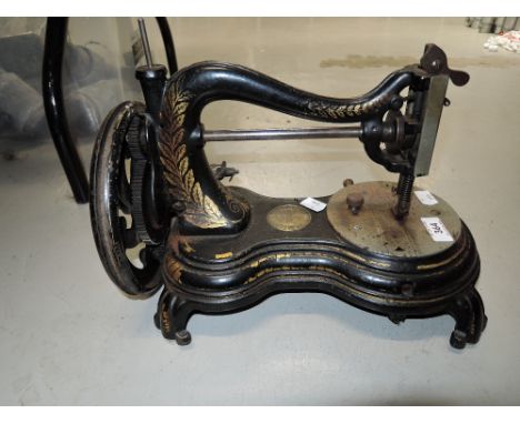 A vintage hand cranked sewing machine with serpentine arm 