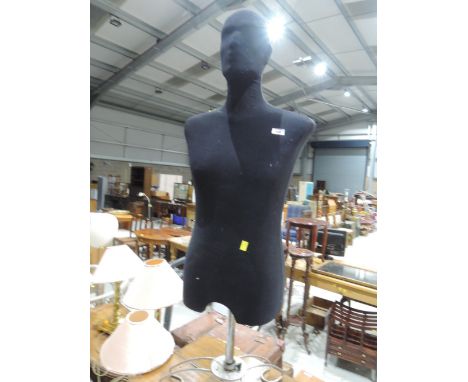 A male torso mannequin on stand