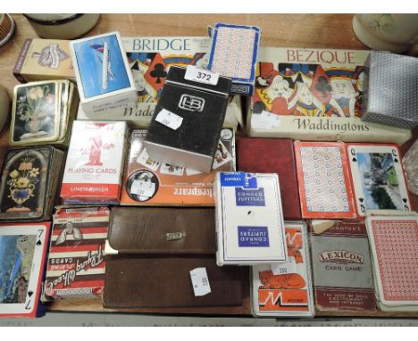 A selection of vintage playing cards and games