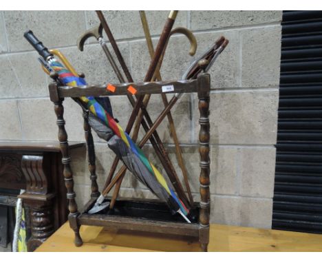 An early 20th Century oak stick stand and sticks etc