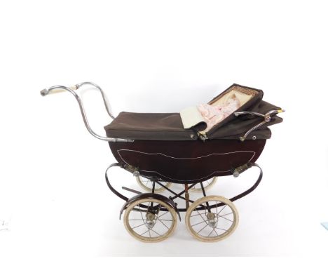 A Silver Cross type brown baby's pram, with coach suspension, together with a porcelain collectors doll.