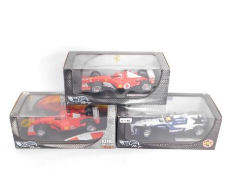 Three Hotwheels racing cars, scale 1:18, comprising Williams F1 Team Ralf Schumacher FW23; Rubens Barrichello F-2002 Ferrari;