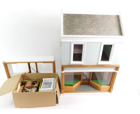 A scale model of a double fronted shop, two storey, with contents, 45.5cm L, 34cm D, 67.5cm H. 