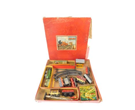 A Chad Valley O gauge train set, tin plate clockwork, with engine and tender, eight wagons, signal, bridge, booking hall, sig