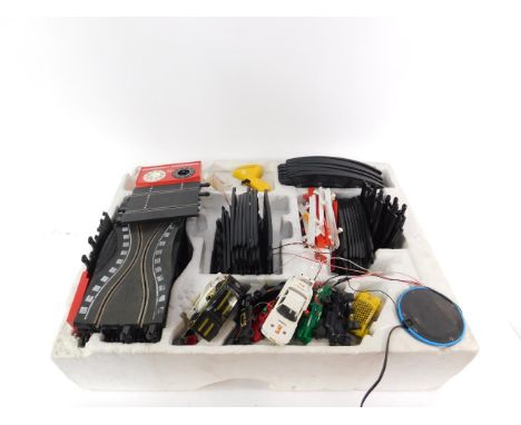 A Scalextric 600 four lane electric model racing set, with four cars, boxed.