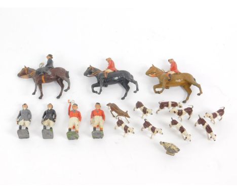 A Britains lead hunting set, comprising three mounted huntsman, four standing figures, a fox and eight hounds, together with 