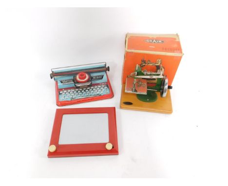 A Grain child's sewing machine, boxed, together with an Etch-A-Sketch, and a Mettoy Minor tin plate toy typewriter. (3)