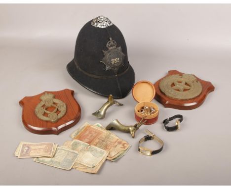 A group of collectables, to include police helmet, military plaques, bank notes etc.  