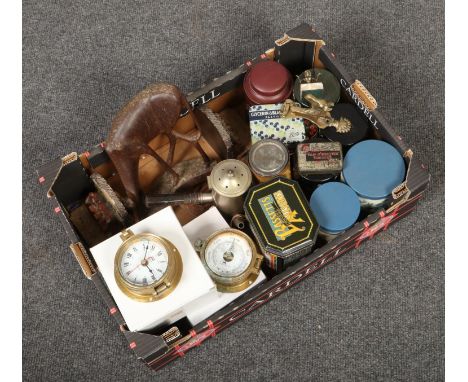 A box of miscellaneous collectables including vintage advertising tins, ships quartz clock and barometer, Shakespeare bookend