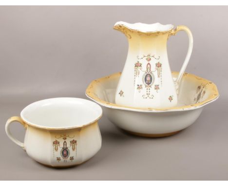 An Edwardian ceramic wash bowl set, large bowl, jug, bowl with floral design  