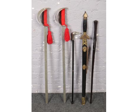 A bundle of swords and sticks to include ebonised walking stick example.  