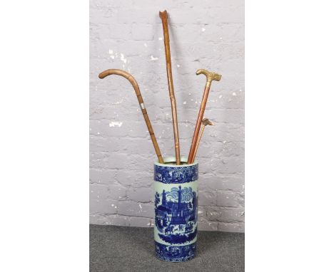 A ceramic stick stand (approx 46 cm height 20 cm width) to include a collection of wooden walking sticks with handle detailin