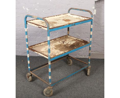 A three tier steel trolley.  Missing one shelf.