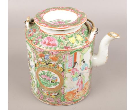 A Cantonese ceramic teapot, decorated with flowers, birds and figures.  Gilt wear to spout. Minor chip underneath lid.