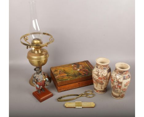 A mixed group lot to include oriental satsuma vases, brass oil lamp, native american scene box etc.  One vase badly cracked.