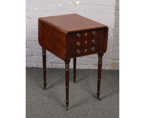 A Regency mahogany two drawer lamp table. With drop leaves and raised on tapering ring turned supports. 53cm x 90cm, 75cm hig
