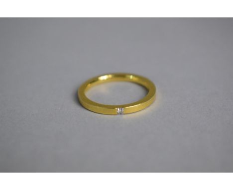 A Contemporary 18ct Gold and Diamond Solitaire Ring, The Small Square Diamond Flush Set on the Band. Total Weight 3.4gms 