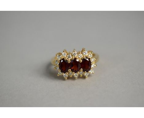 A 9ct Gold, Diamond and Garnet Cluster Ring, 4.1gms. 