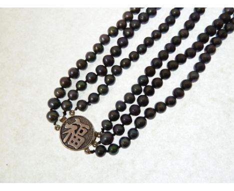 THREE STRAND CULTURED BLACK PEARL NECKLACE, uniform pearls 6mm-6.5mm approx., with silver metal clasp with oriental character