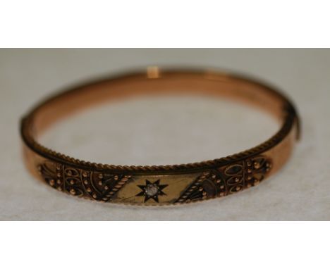 EDWARDIAN DIAMOND SET 9CT GOLD HINGE OPENING BANGLE, to set with a single small old cut diamond, with filigree detail and rop