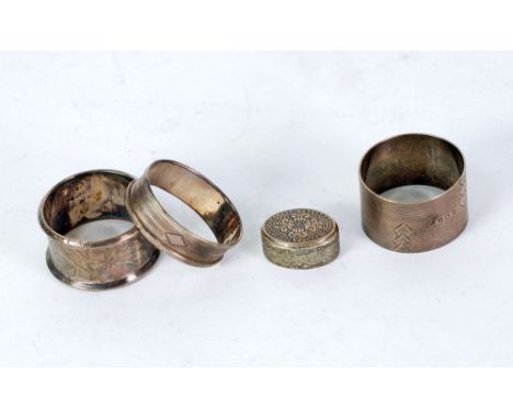 THREE SILVER NAPKIN RINGS, and an OVAL PATCH BOX (900 standard) with neillo work top and engraved sides, 1 1/4" x 1" (3.2cm x