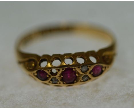 EDWARDIAN 18CT GOLD, RUBY AND DIAMOND SET RING, boat shaped top set with three graduated rubies and three small diamonds (plu