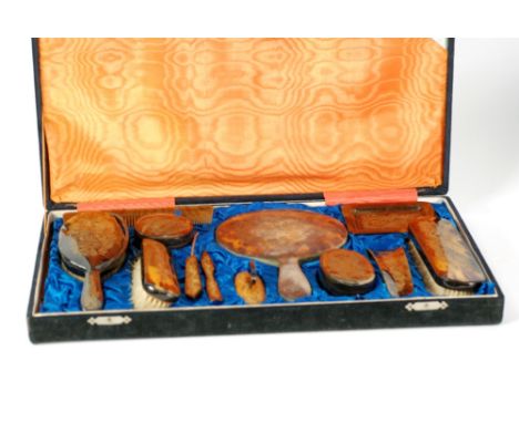 CASED TWELVE PIECE SIMULATED TORTOISESHELL DRESSING TABLE SET; engraved with gilt Chinese dragon decoration, comprising; hand