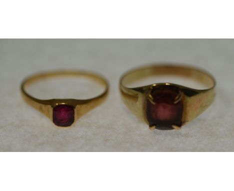 GARNET SET RING, claw set oval mixed cut garnet to the tapering unmarked gold band (tests 14-18ct), size P ½, 2.6g AND A RUBY