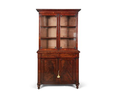 A WILLIAM IV FLAME MAHOGANY BOOKCASE, c.1830, of rectangular form with cavetto cornice above twin glazed panel doors, enclosi