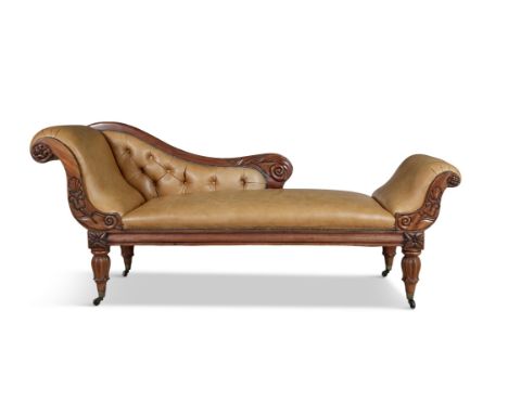 A VICTORIAN MAHOGANY AND BUTTON BACKED UPHOLSTERED DAY BED, covered in tan leather, with scroll ends, and lotus carved taperi