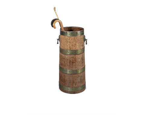 A COOPERED BRASS BOUND OAK STICK STAND, with lion mask hoop handles. 77.5cm high