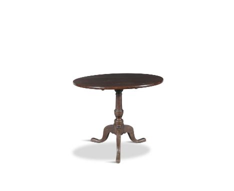 A GEORGE IV MAHOGANY TILT TOP TABLE, raised on turned baluster centre pillar, raised on triform base. 83.5cm diameter, 70cm h