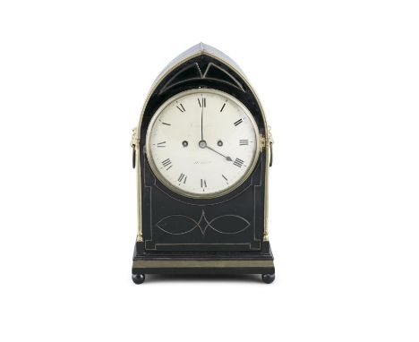 AN IRISH EBONISED MANTLE CLOCK, by Chancellor, Dublin, of arched shape, the body with lion mask ring carrying handles, enclos