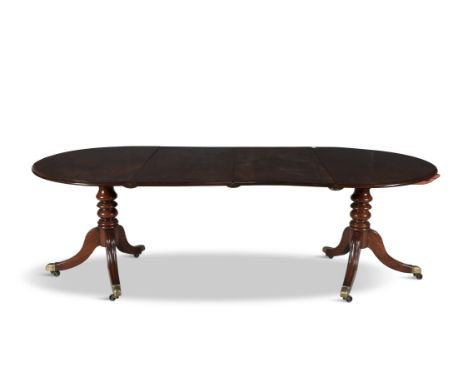 A GEORGE III MAHOGANY D-END DINING TABLE, the top with moulded rim, raised on twin turned pillar tripod supports terminating 