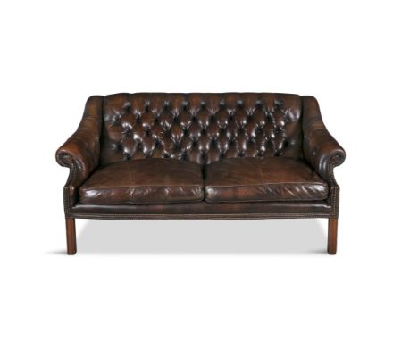 A 19TH CENTURY BROWN LEATHER CHESTERFIELD SETTEE, with square button back and downswept armrests, raised on square channelled