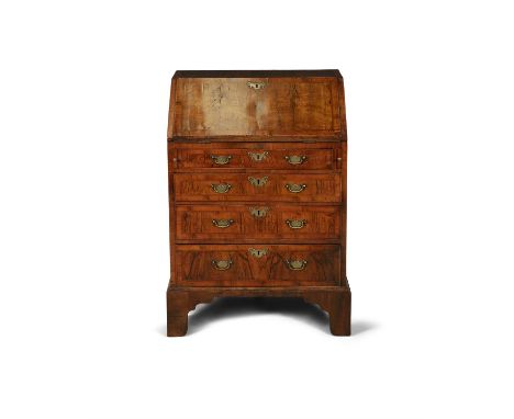 A GEORGE II STYLE INLAID WALNUT FALL FRONT BUREAU, of compact proportions, the slope writing surface enclosing a fitted inter