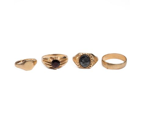 Four 9ct gold men's rings, including a Roman soldier carved hematite, size U; and a garnet set ring, size V; together with a 