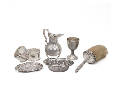 Collection of hallmarked silver to include two napkin rings, two pin dishes, an egg cup, a creamer and a table brush. Weighab