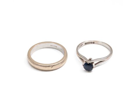 18ct white hallmarked gold engagement ring, set with a sapphire; and an 18ct gold wedding band, both size J. Combined weight 